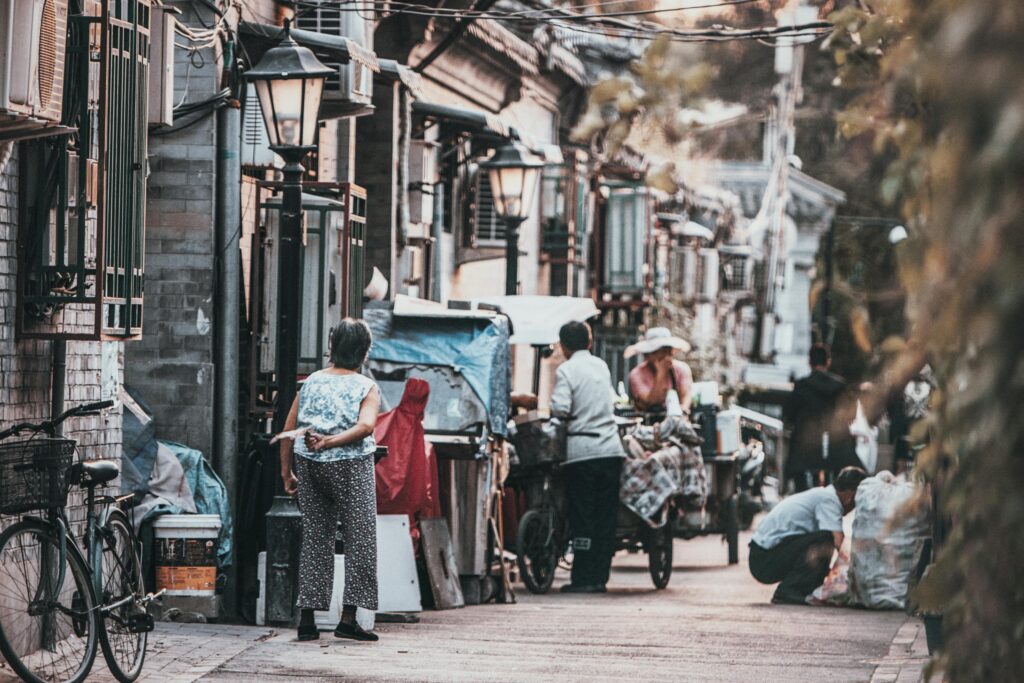 Livet är som en poker. Inte schak A glimpse into the vibrant street life of a traditional hutong in Beijing, China, showcasing daily interactions.